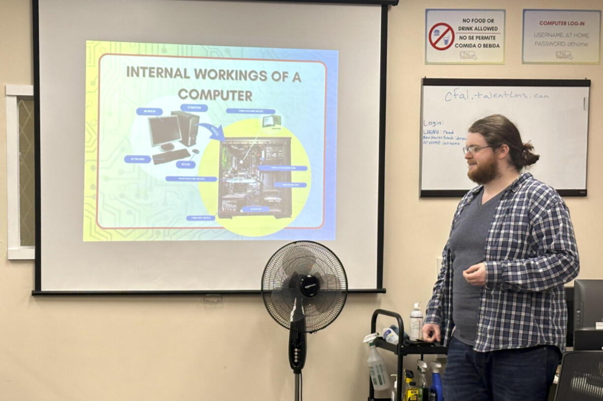 In this undated photo, Richie Hull, a lead instructor at the Connecticut-based group CfAL for Digital Inclusion, teaches the Foundation to a Career in Computers class at the organization&rsquo;s computer lab in New Haven, Conn. States are looking to beef up their residents tech skills as generative artificial intelligence plays a greater role in the workplace. CfAL officials, however, say basic computer skills are also still needed.