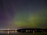 The northern lights, or aurora borealis, are visible over Lake Washington, in Renton, Wash., on Friday evening, May 10, 2024.