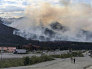 This photo provided by the National Park Service shows a wildfire burning about a mile north of Denali National Park and Preserve, Alaska, on June 30, 2024, as seen from a tourist area outside the park that's home to hotels, gift shops and restaurants. The fire prompted the national park into a temporary closure Monday.