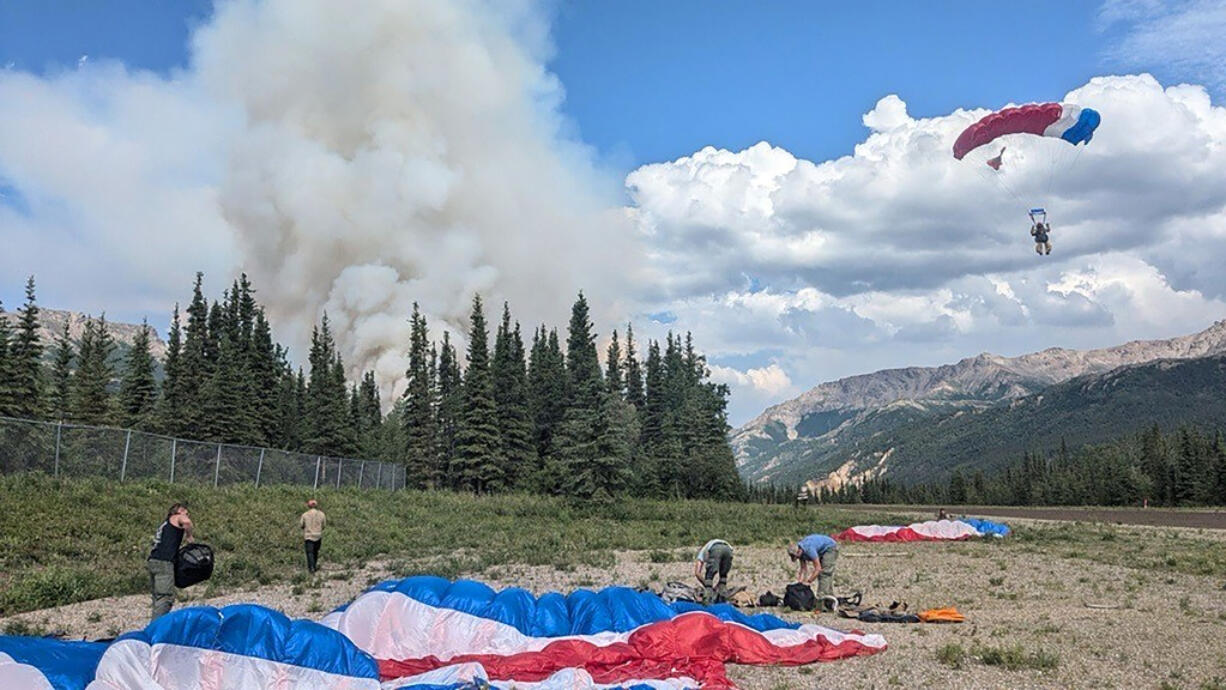 In this photo provided by the National Park Service smokejumpers arrive on scene in Denali National Park and Preserve to fight a wildfire burning about a mile north of the park's only entrance on June 30, 2024. The fire forced the temporary closure of the park on Monday, July 1, 2024.