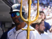 Seattle Mariners' Julio Rodríguez holds a trident in the dugout after his solo home run against the Baltimore Orioles during the fifth inning of a baseball game Thursday, July 4, 2024, in Seattle.