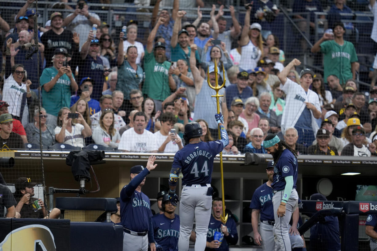 Seattle Mariners' Julio Rodriguez (44) celebrates his home run with teammates during the fifth inning of a baseball game against the San Diego Padres, Tuesday, July 9, 2024, in San Diego.