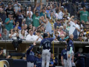 Seattle Mariners' Julio Rodriguez (44) celebrates his home run with teammates during the fifth inning of a baseball game against the San Diego Padres, Tuesday, July 9, 2024, in San Diego.