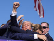 Republican presidential candidate former President Donald Trump is surrounded by U.S. Secret Service agents at a campaign rally, Saturday, July 13, 2024, in Butler, Pa.