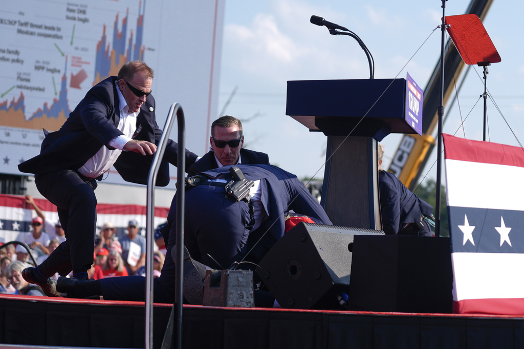 U.S. Secret Service agents converge to cover Republican presidential candidate former President Donald Trump at a campaign rally, Saturday, July 13, 2024, in Butler, Pa.