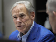 Gov. Greg Abbott receives a briefing for Hurricane Beryl from local elected officials Sunday, July 14, 2024, at Gallery Furniture in Houston.