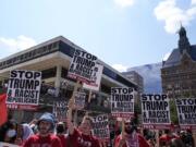 Protestors speak at Red Arrow Park near the Fiserv Forum during the first day of the 2024 Republican National Convention, Monday, July 15, 2024, in Milwaukee. (AP Photo/Jae C.