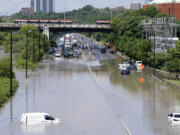 Cars are partially submerged in flood waters in the Don Valley following heavy rain in Toronto, on Tuesday, July 16 2024.