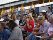 A woman wipes her face during a vigil for Corey Comperatore, the former fire chief shot and killed at a weekend rally for former President Donald Trump, Wednesday, July 17, 2024, at Lernerville Speedway in Sarver, Pa.