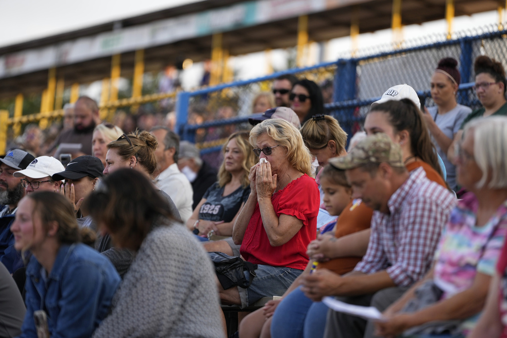 A woman wipes her face during a vigil for Corey Comperatore, the former fire chief shot and killed at a weekend rally for former President Donald Trump, Wednesday, July 17, 2024, at Lernerville Speedway in Sarver, Pa.