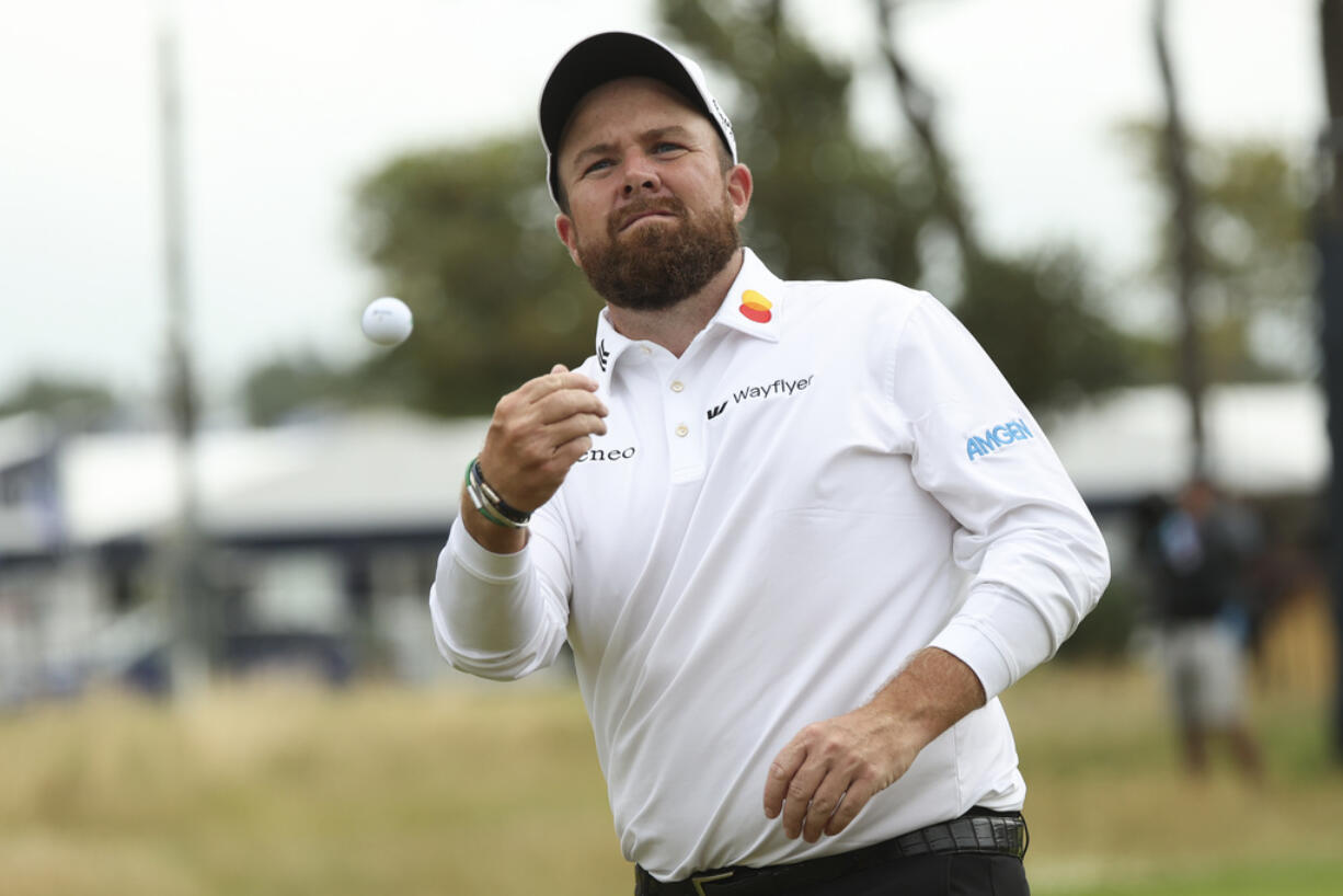 Shane Lowry of Ireland throws his ball into the stands as he walks from the 18th green following his second round of the British Open Golf Championships at Royal Troon golf club in Troon, Scotland, Friday, July 19, 2024.