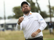 Shane Lowry of Ireland throws his ball into the stands as he walks from the 18th green following his second round of the British Open Golf Championships at Royal Troon golf club in Troon, Scotland, Friday, July 19, 2024.
