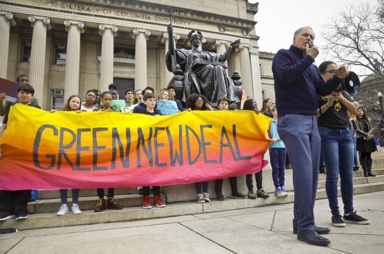 FILE - Democratic presidential candidate Washington Gov. Jay Inslee, second from right, speak during a Columbia Climate Strike rally at Columbia University March 15, 2019, in New York.