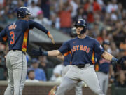 Houston Astros' Jake Meyers, right, celebrates with Jeremy Pena after hitting a two-run home run during the seventh inning of a baseball game against the Seattle Mariners, Saturday, July 20, 2024, in Seattle.