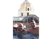 This October 2014 photo obtained by The Associated Press shows then-U.S. Drug Enforcement Administration Agents Jose Irizarry and George Zoumberos in a rooftop pool at a luxury hotel in Cartagena, Colombia, during a DEA assignment for "Operation White Wash." Irizarry long considered Zoumberos a brother but in his interviews with investigators accused his former partner of a list of crimes.