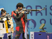 China's Sheng Lihao, right, and teammate Huang Yuting compete for the gold medal in the 10m air rifle mixed team medal round at the 2024 Summer Olympics, Saturday, July 27, 2024, in Chateauroux, France.