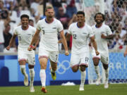 United States' Walker Zimmerman, center, celebrates after scoring his side's second goal during the men's Group A soccer match between New Zealand and the United States at the Velodrome stadium, during the 2024 Summer Olympics, Saturday, July 27, 2024, in Marseille, France.