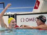 Ariarne Titmus, of Australia, left, celebrates after winning the women's 400-meter freestyle final as Katie Ledecky, of the United States, reacts at the 2024 Summer Olympics, Saturday, July 27, 2024, in Nanterre, France.