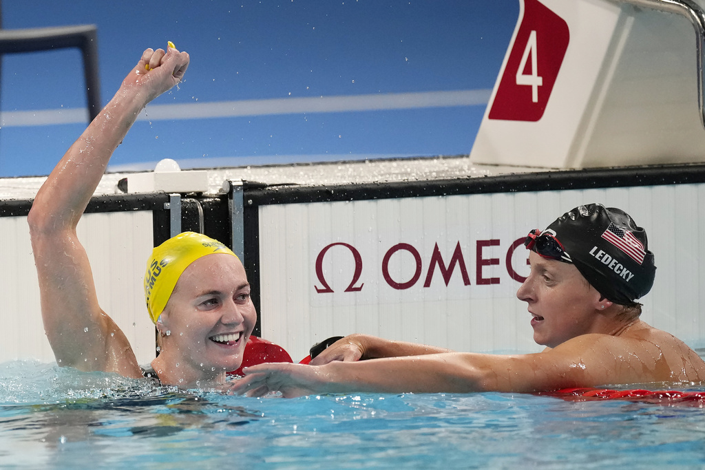 Ariarne Titmus, of Australia, left, celebrates after winning the women's 400-meter freestyle final as Katie Ledecky, of the United States, reacts at the 2024 Summer Olympics, Saturday, July 27, 2024, in Nanterre, France.