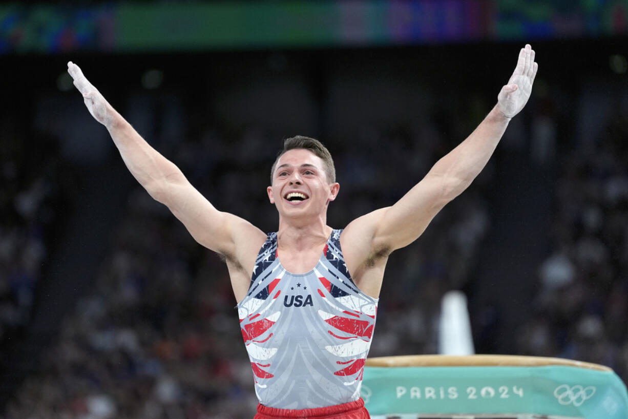 Paul Juda, of the United States, celebrates after performing on the vault during the men's artistic gymnastics team finals round at Bercy Arena at the 2024 Summer Olympics, Monday, July 29, 2024, in Paris, France.