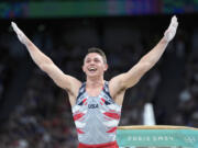 Paul Juda, of the United States, celebrates after performing on the vault during the men's artistic gymnastics team finals round at Bercy Arena at the 2024 Summer Olympics, Monday, July 29, 2024, in Paris, France.