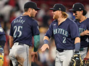 Seattle Mariners Justin Turner (2) celebrates with Dylan Moore (25) after defeating the Boston Red Sox 10-6 following a baseball game, Tuesday, July 30, 2024, in Boston.