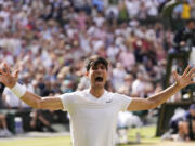 Carlos Alcaraz of Spain celebrates after defeating Novak Djokovic of Serbia in the men&#039;s singles final at the Wimbledon tennis championships in London, Sunday, July 14, 2024.
