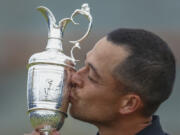 Xander Schauffele of the United States kisses the Claret Jug trophy after winning the British Open Golf Championships at Royal Troon golf club in Troon, Scotland, Sunday, July 21, 2024.