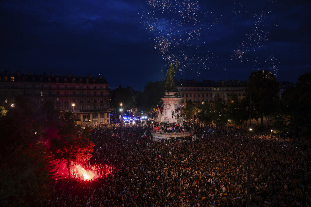 People gather at the Republique plaza after the second round of the legislative election, Sunday, July 7, 2024 in Paris. Surprise polling projections in France say a leftist coalition that came together to try to keep the far right from power has won the most parliamentary seats in runoff elections. There was high voter turnout.