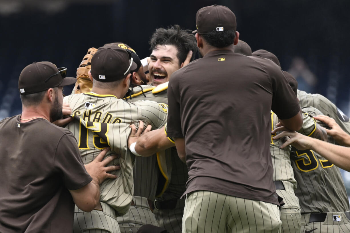 San Diego Padres team members join in the celebration for Padres starting pitcher Dylan Cease, center, for his no-hitter after nine complete innings of a baseball game against the Washington Nationals, Thursday, July 25, 2024, in Washington.