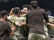 San Diego Padres team members join in the celebration for Padres starting pitcher Dylan Cease, center, for his no-hitter after nine complete innings of a baseball game against the Washington Nationals, Thursday, July 25, 2024, in Washington.