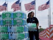 Staff at Lakewood Church hand out water and operate a cooling station in Houston, Tuesday, July 9, 2024. The effects of Hurricane Beryl left most in the area without power.