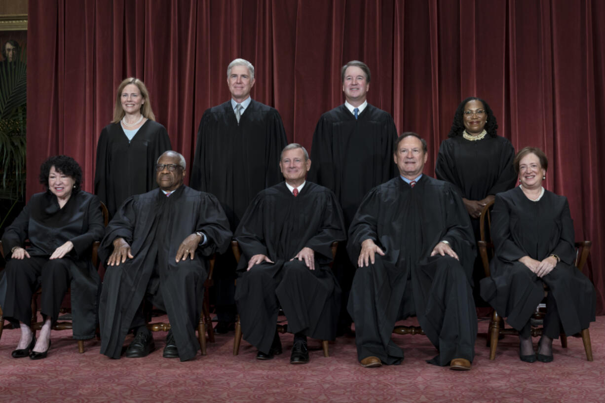 FILE - Members of the Supreme Court sit for a group portrait at the Supreme Court building in Washington, Oct. 7, 2022. Bottom row, from left, Justice Sonia Sotomayor, Justice Clarence Thomas, Chief Justice of the United States John Roberts, Justice Samuel Alito, and Justice Elena Kagan. Top row, from left, Justice Amy Coney Barrett, Justice Neil Gorsuch, Justice Brett Kavanaugh, and Justice Ketanji Brown Jackson. As the U.S. Supreme Court is expected to rule on a major case involving former President Donald Trump, 7 in 10 Americans think its justices are more likely to shape the law to fit their own ideology, rather than serving as neutral arbiters of government authority, according to a new poll.  (AP Photo/J.