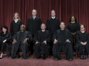 FILE - Members of the Supreme Court sit for a group portrait at the Supreme Court building in Washington, Oct. 7, 2022. Bottom row, from left, Justice Sonia Sotomayor, Justice Clarence Thomas, Chief Justice of the United States John Roberts, Justice Samuel Alito, and Justice Elena Kagan. Top row, from left, Justice Amy Coney Barrett, Justice Neil Gorsuch, Justice Brett Kavanaugh, and Justice Ketanji Brown Jackson. As the U.S. Supreme Court is expected to rule on a major case involving former President Donald Trump, 7 in 10 Americans think its justices are more likely to shape the law to fit their own ideology, rather than serving as neutral arbiters of government authority, according to a new poll.  (AP Photo/J.