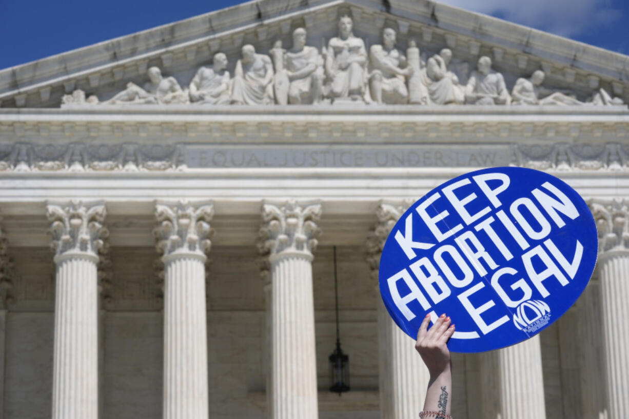 FILE - A person holds up a sign as abortion-rights activists and Women&rsquo;s March leaders protest as part of a national day of strike actions outside the Supreme Court, Monday, June 24, 2024, in Washington. A growing number of women said they&rsquo;ve tried to end their pregnancies on their own by doing things like taking herbs, drinking alcohol or even hitting themselves in the belly, a new study suggests. Researchers surveyed reproductive-age women in the U.S. before and after the Supreme Court overturned Roe v. Wade in June 2022.