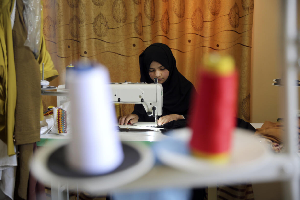 An Afghan woman tailor works with a sewing machine in the Afghan Women Business Hub in Kabul, Afghanistan, Tuesday, July 2, 2024. Half of Afghanistan&rsquo;s population now finds itself locked out of the freedom to work at a time when the country&rsquo;s economy is worse than ever, with few jobs available to women in the country.