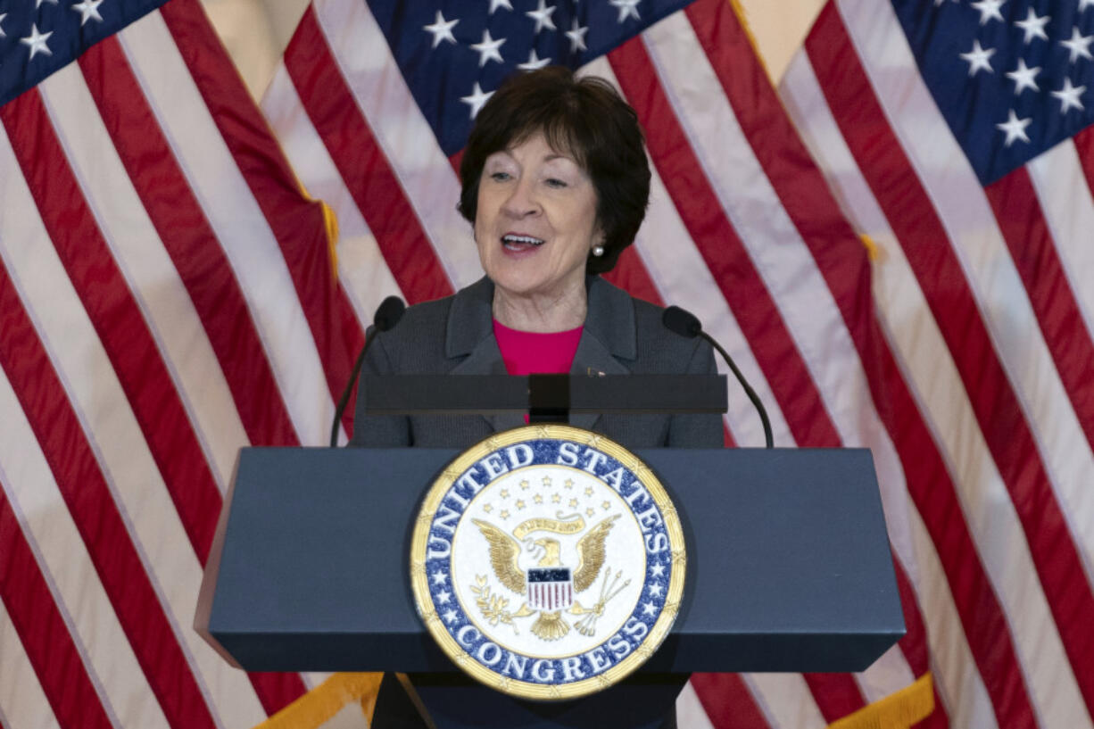 FILE - Sen. Susan Collins, R-Maine, speaks in front of American flags during the Congressional Gold Medal ceremony in honor of &quot;Rosie the Riveter&quot;, Wednesday, April 10, 2024, on Capitol Hill in Washington. Congress has passed a proposal to require the federal government to only purchase American flags completely manufactured in the U.S.  Supporters of the proposal, led by Republican Sen. Susan Collins of Maine and Democratic Sen. Sherrod Brown of Ohio, said the change is more than just symbolic.