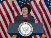 FILE - Sen. Susan Collins, R-Maine, speaks in front of American flags during the Congressional Gold Medal ceremony in honor of &quot;Rosie the Riveter&quot;, Wednesday, April 10, 2024, on Capitol Hill in Washington. Congress has passed a proposal to require the federal government to only purchase American flags completely manufactured in the U.S.  Supporters of the proposal, led by Republican Sen. Susan Collins of Maine and Democratic Sen. Sherrod Brown of Ohio, said the change is more than just symbolic.