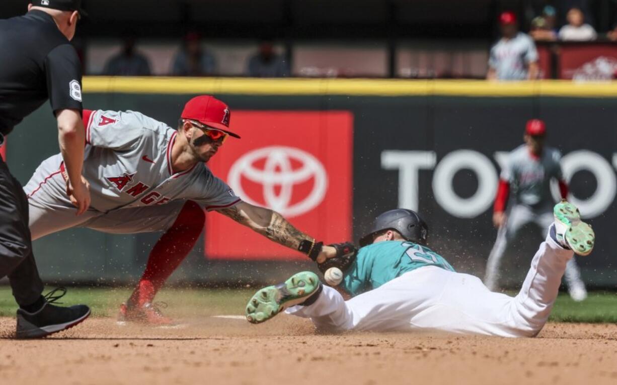 Los Angeles Angels shortstop Zach Neto loses the ball on the tag attempt on Seattle Mariners&#039; Luke Raley in the seventh inning of a baseball game, Wednesday, July 24, 2024, in Seattle.