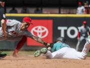 Los Angeles Angels shortstop Zach Neto loses the ball on the tag attempt on Seattle Mariners&#039; Luke Raley in the seventh inning of a baseball game, Wednesday, July 24, 2024, in Seattle.