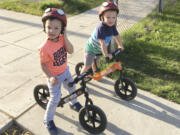 Jackson, left, and Owen Pezalla, both 4, appear on balance bicycles in Seattle on July 1, 2017. Experts recommend starting with those so-called balance bikes at a younger-than-expected age, possibly even less than a year old.