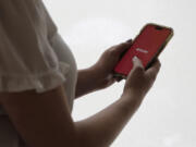 The dating app Tinder is shown on a smartphone on Wednesday, June 26, 2024, in New York. Plenty of happy couples can trace their meet-cute moment to an online dating app. But many others find the never-ending process of likes, swipes, taps and awkward DMs that go nowhere to be exhausting.