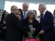 President Joe Biden greets people after arriving at Harry Reid International Airport in Las Vegas, Monday, July 15, 2024.