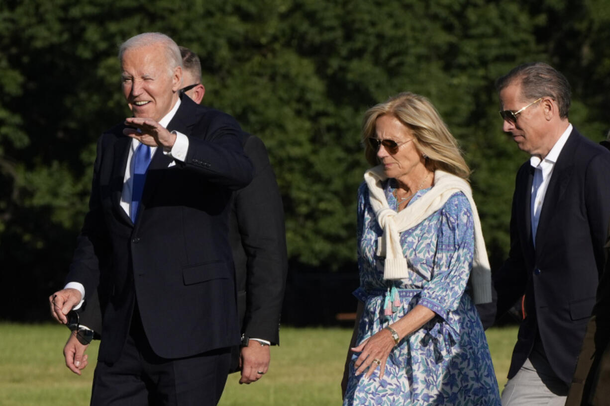 President Joe Biden, from left, waves as he arrives at Fort Lesley J. McNair accompanied by first lady Jill Biden and son Hunter Biden, Monday, July 1, 2024, in Washington, on return from Camp David.