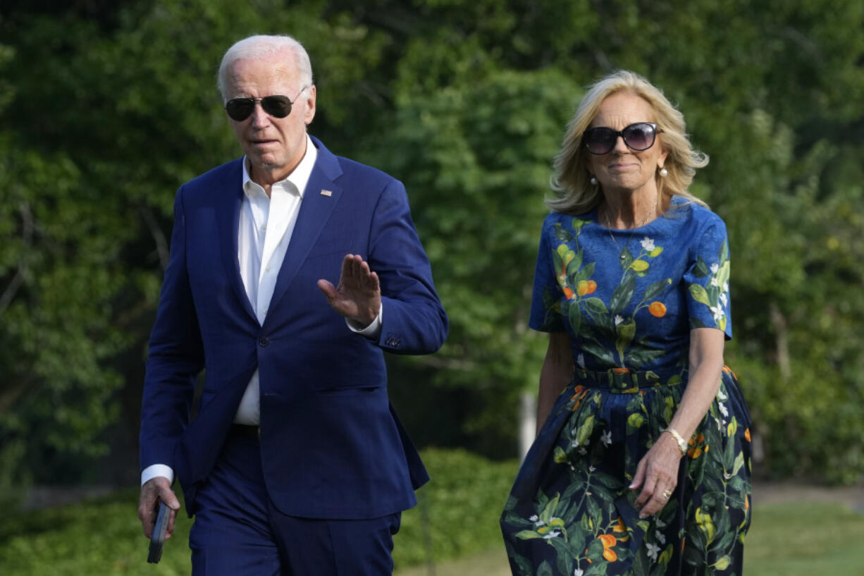 President Joe Biden, left, and first lady Jill Biden walk on the South Lawn of the White House in Washington, Sunday, July 7, 2024, after returning from events in Pennsylvania.