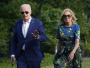 President Joe Biden, left, and first lady Jill Biden walk on the South Lawn of the White House in Washington, Sunday, July 7, 2024, after returning from events in Pennsylvania.