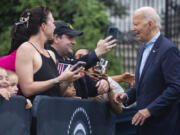 President Joe Biden greets active-duty military service members and their families on the South Lawn of the White House on Thursday in Washington.