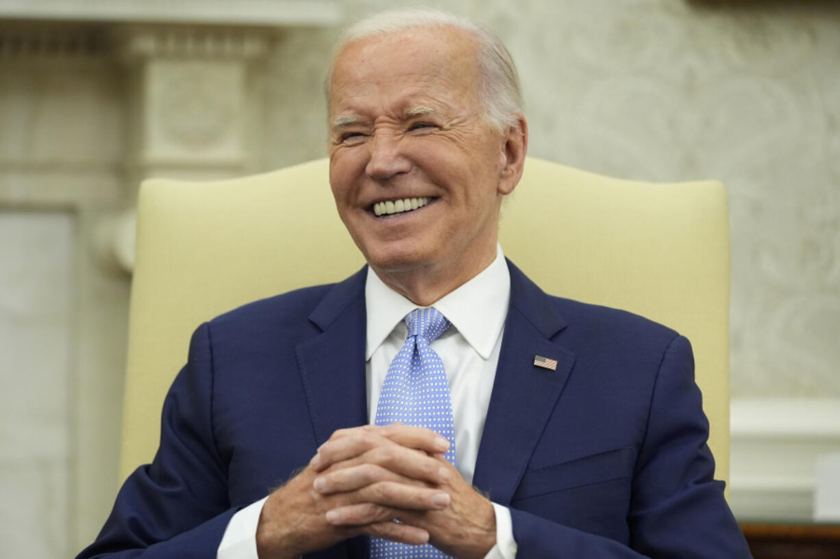 President Joe Biden similes as he meets with British Prime Minister Keir Starmer in the Oval Office of the White House, Wednesday, July 10, 2024, in Washington.