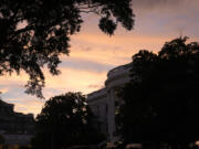 The sun sets over the White House after President Joe Biden speaks at a news conference following the NATO Summit in Washington, Thursday, July 11, 2024.