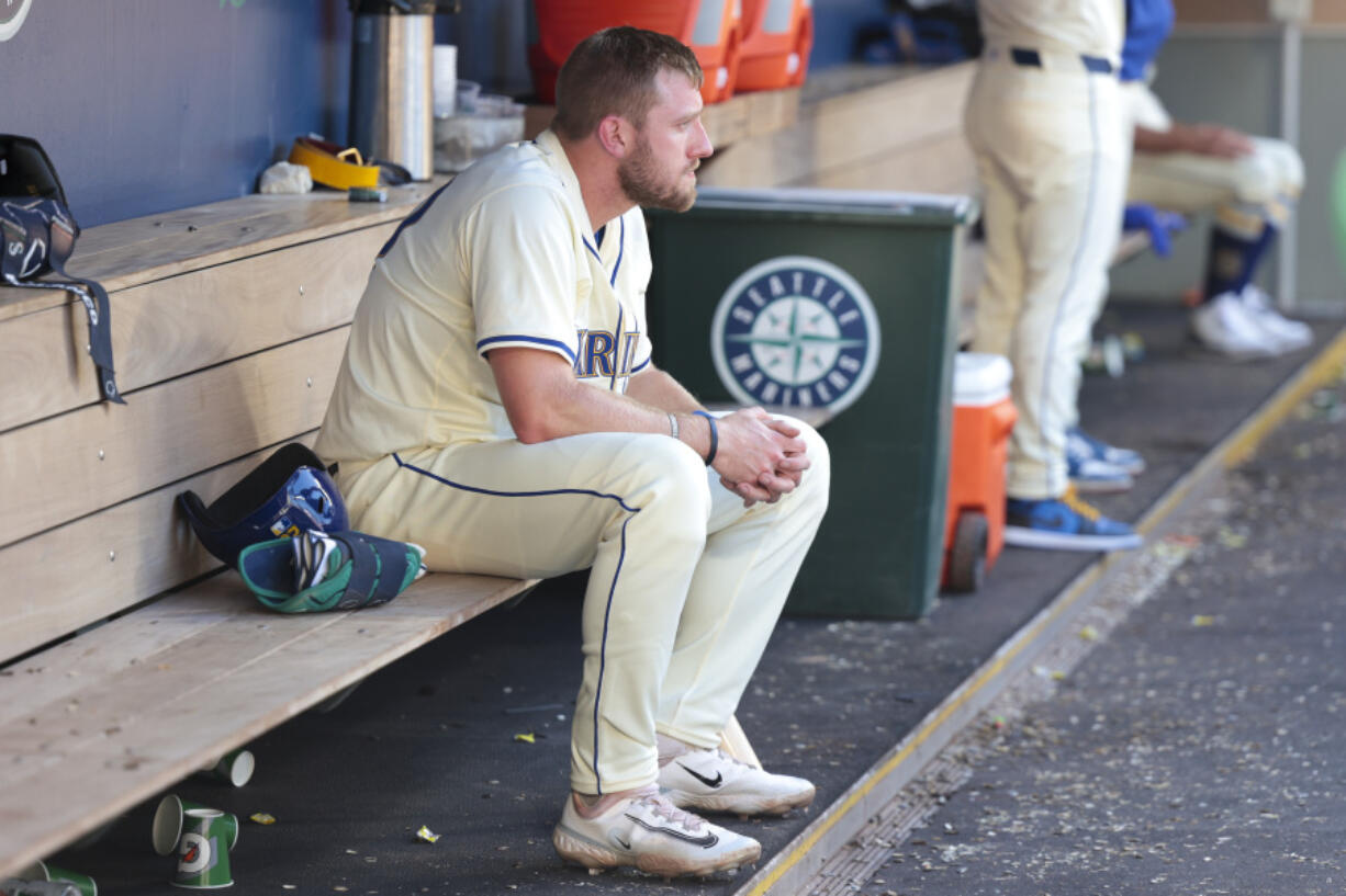 Seattle Mariners outfielder Luke Raley sits in the dugout following a loss to the Toronto Blue Jays in the 10th inning of a baseball game, Sunday, July 7, 2024, in Seattle.